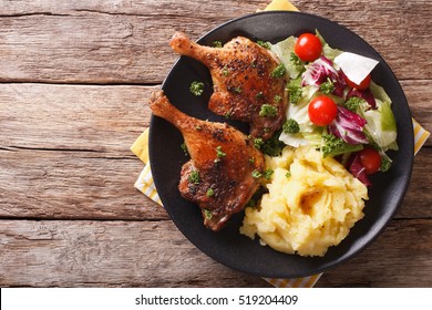 Roasted Duck Leg With Mashed Potatoes And Fresh Salad On The Plate Closeup. Horizontal View From Abovel
