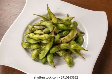 Roasted Edamame On A White Plate