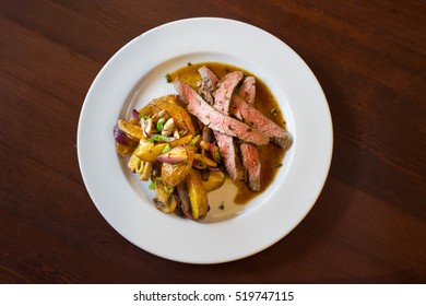 Roasted Flank Steak With Baked Potatoes And Vegetables 