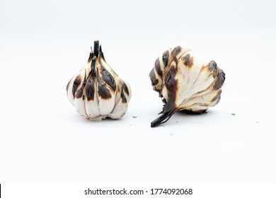 Roasted Garlic Cloves And Bulb In White Background.