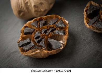 Roasted Garlic Cloves Over Black And Copy Space