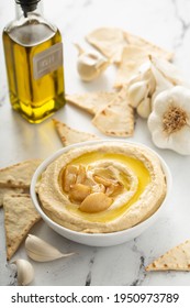 Roasted Garlic Hummus Topped With Olive Oil And Garlic Cloves