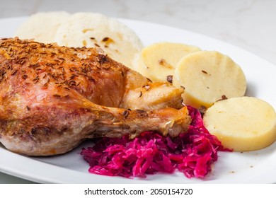 roasted goose leg with red cabbage and dumplings