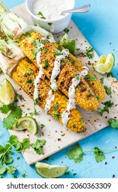 Roasted Or Grilled Sweet Corn Cobs With Garlic, Coriander, Lime . Mexican Street Food. Top Down View.