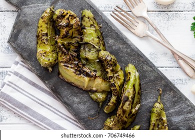 Roasted Hatch Chili Peppers On The Cutting Board. Fall Harvest. Summer Menu. Rustic Style. Vegetarian Menu. Green Chilies. Hatch Chile Festival.