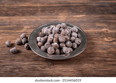 Roasted hazelnuts in shell on old wooden table