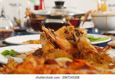 Roasted Jumbo Prawns  With Salt, Pepper, Sauce  And Fresh Vegetables On White Oval Plate, Isolated On Blue Background, Low Angle Back Side View, Macro Close-up Focus At The Middle Of Food 