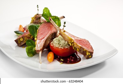 Roasted Lamb Chops with Pistachio. Garnished with Vegetables and Basil