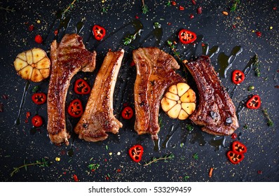 Roasted Lamb Cutlets Ribs With Garlic And Herbs On Stone Background