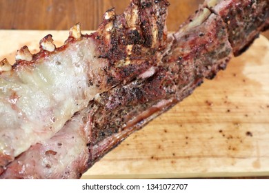 Roasted lamb rack serving on wooden cutting board