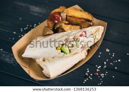 Roasted meat and vegetables taco wooden background. Mexican cuisine snacks, fast food of commercial kitchen