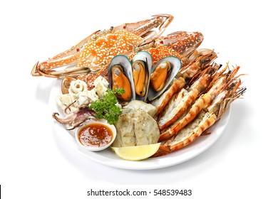 Roasted Mixed Seafood Contain Blue Crabs, Mussels, Jumbo Prawns, Calamari Squids And Grilled Barracuda Fish Garlic With Spicy Chili Sauce And Lemon On Platter, Isolated On White Background With Shadow