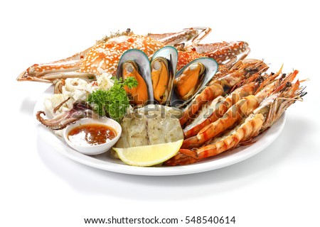 Roasted Mixed Seafood Contain Blue Crabs, Mussels, Big Shrimps, Calamari Squids and Grilled Barracuda Fish Garlic with Spicy Chili Sauce and Lemon on Dish, Isolated on White Background with Shadow.