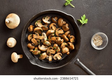 Roasted mushroom in cast iron pan over dark stone background. Vegetarian vegan food concept. Top view, flat lay - Powered by Shutterstock