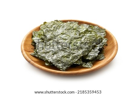roasted nori laver seaweed snack in wood plate isolated on white background. nori laver seaweed crispy in wood plate isolated on white background. Gim, laver, nori, isolated