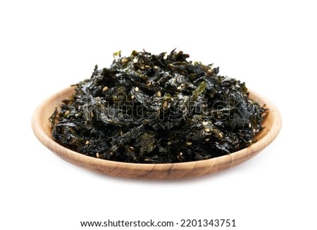 roasted nori seaweed and sesame topping in wood plate isolated on white background. nori laver seaweed crispy isolated on white background. Gim, laver, nori, isolated