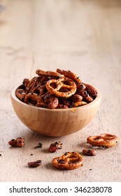 Roasted Nuts Mix And Pretzel In Wooden Bowl
