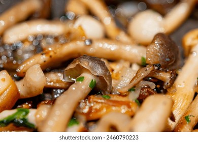 Roasted with onion white and brown shimeji edible mushrooms native to East Asia, buna-shimeji is widely cultivated and rich umami tasting compounds close up - Powered by Shutterstock