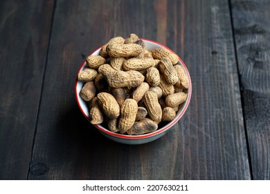 Roasted peanuts with the outer shell. Indonesian peanut dish. Deep fried peanuts.   