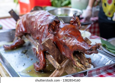 Roasted pig on the traditional barbecue. Grilled pig on the market of Bali, Indonesia, close up