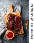 Roasted Pork Ribs in BBQ Sauce with Red Beans on a cutting board. High quality photo