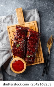 Roasted Pork Ribs in BBQ Sauce with Red Beans on a cutting board. High quality photo