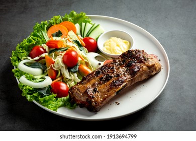 Roasted Pork Steak And Vegetables On Plate.