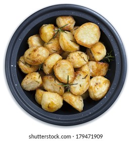 Roasted Potatoes In Black Dish, With Rosemary And Sea Salt Flakes.  Isolated On White.