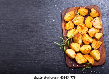 Roasted Potatoes With Rosemary On Dark Background, Top View