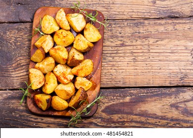 Roasted Potatoes With Rosemary On Wooden Table, Top View