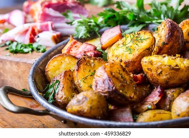 Roasted Potatoes With Smoked Bacon Garlic Salt Pepper Cumin Dill And Herb Decoration.