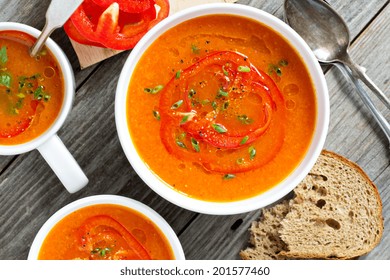 Roasted Red Pepper And Carrot Soup In White Bowl