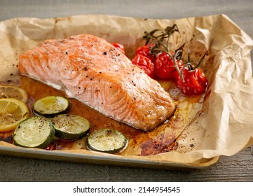 Roasted Salmon Filet And Vegetables On Oven Pan