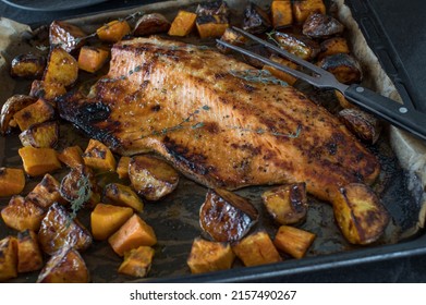 Roasted Salmon With Potatoes On A Baking Tray. Closeup