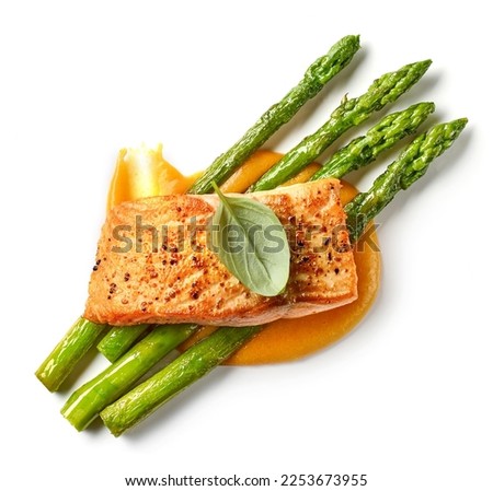 roasted salmon steak and vegetables isolated on white background, top view