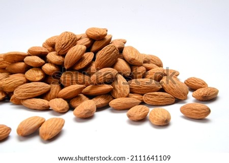 Roasted salted raw cashew nuts in wooden bowl on rustic table, healthy vegetarian snack,Fresh almonds in the wooden bowl, Organic almonds, almonds border white background, Almond nuts on a dark wooden
