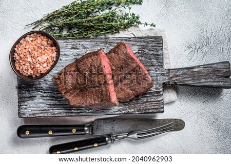Roasted Shoulder Top Blade or flat iron beef meat steaks on wooden board. White background. Top View ストックフォト © 