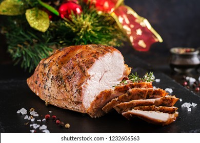 Roasted Sliced Christmas Ham Of Turkey On Dark Rustic Background. Festival Food.