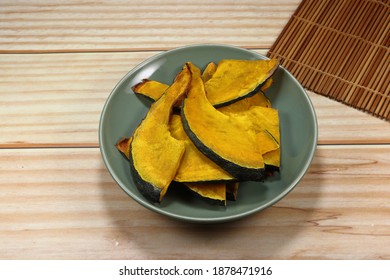 Roasted Sliced Fresh Pumpkin On The Plate. Famous Vegetarian Snack For Diet. High Fiber And Nutrition Food. 