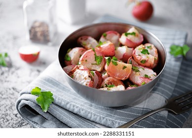 Roasted spiced radish with parsley in a bowl. toning. selective focus