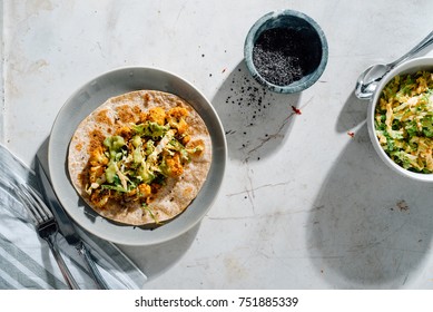 Roasted, Spicy Cauliflower Taco With Creamy Asian Slaw On Gray Plate With Black Sesame Seeds, Gochujang And Spicy Slaw In The Background.