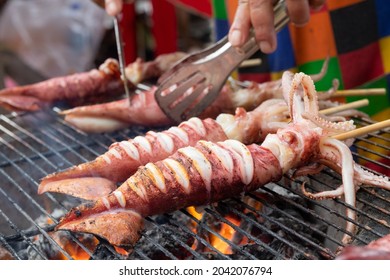 Roasted Squid Skewers On Stove, Thai Street Food
