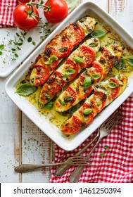 Roasted, Stuffed Zucchini With The Addition Of Tomatoes, Mozzarella Cheese, Fresh Basil And Olive Oil (caprese Salad) In A Ceramic Baking Dish, Close-up, Top View. Nutritious And Tasty Vegetarian Dish