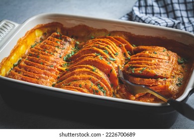 Roasted sweet potato gratin with parsley in a ceramic pan, close-up. Vegan healthy recipe concept. - Shutterstock ID 2226700689