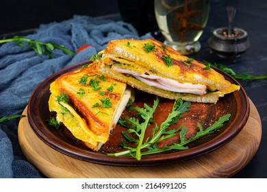 Roasted Toast In Scrambled Eggs With Ham, Herbs And Cheese Cheddar. Delicious Grilled Breakfast Sandwich