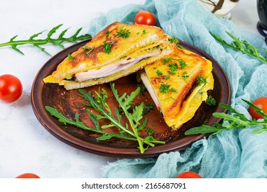 Roasted Toast In Scrambled Eggs With Ham, Herbs And Cheese Cheddar. Delicious Grilled Breakfast Sandwich