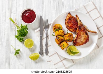 Roasted Tomahawk Pork Chops, Bone-in Steak With Grilled Corn Disks And Lime On White Plate On White Wooden Table With Barbeque Sauce, Horizontal View From Above, Flat Lay