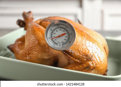 Roasted Turkey With Meat Thermometer In Baking Dish