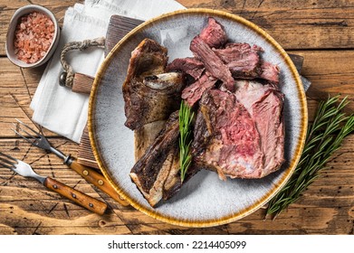 Roasted Veal Beef Short Ribs In Plate With Rosemary. Wooden Background. Top View.
