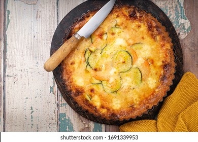 Roasted vegetable quiche. Easy sweet potato zucchini pie tart on rustic background with copy space. Top view. Healthy food concept. French cuisine.